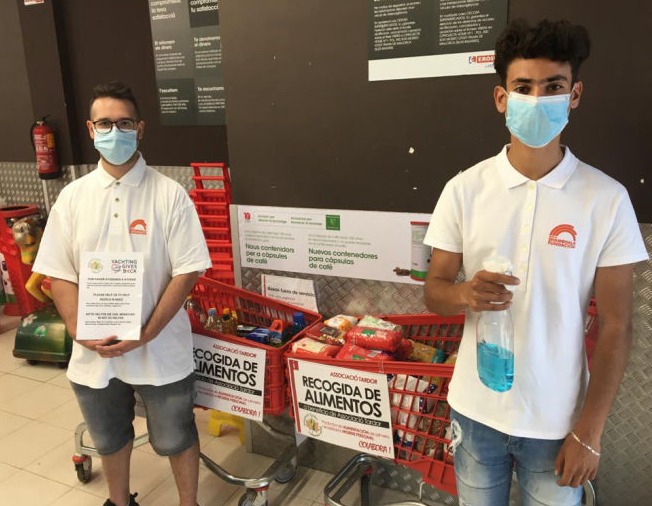 Two youngsters in front of supermarket collection carts