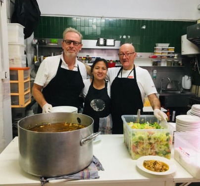 Two men and a woman in a kitchen
