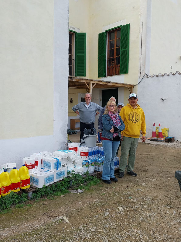Two ladies next to bags of bedding