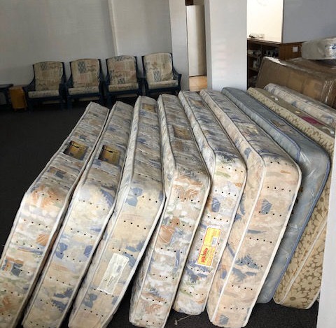 A pile of mattresses on the floor of the shelter Llar Kurt