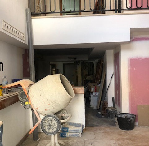 A cement mixer in the middle of the floor