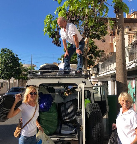 The YGB volunteers pack a van with donated bedlinen