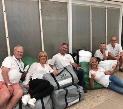 The YGB volunteers have a rest on top of the bags of bedding