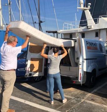 The YGB volunteers fill up a delivery van with mattresses