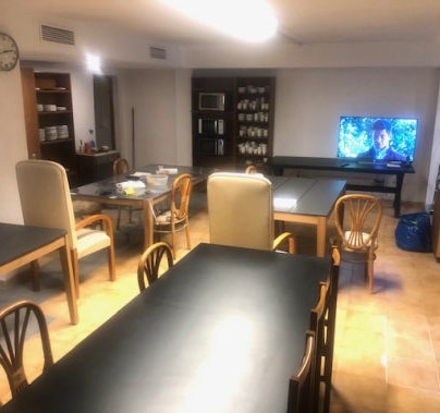 A communal dining room with four large tables