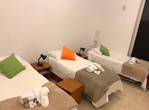 A room in a shelter with various neatly made beds