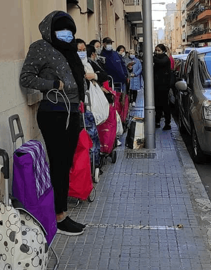 People in a line at a soup kitchen