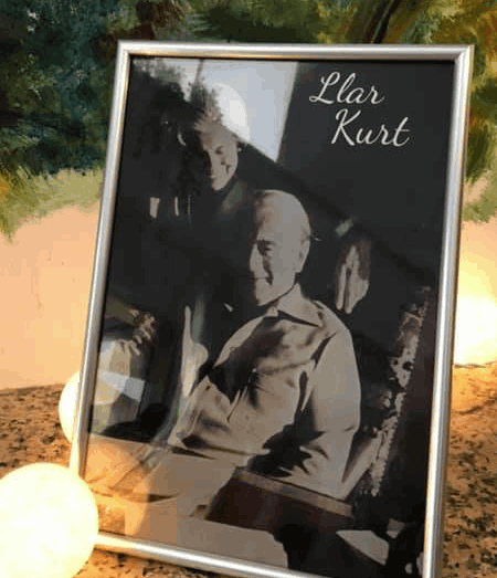 A framed back and white photograph of a smiling couple