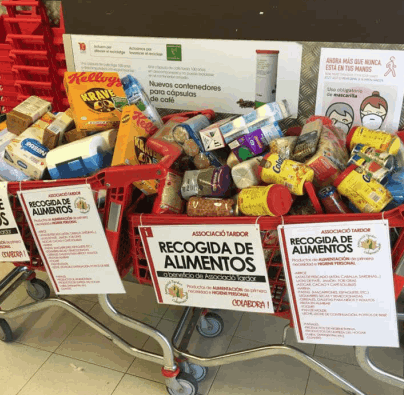 Two shopping trolleys full of food stuff at a supermarket food collection