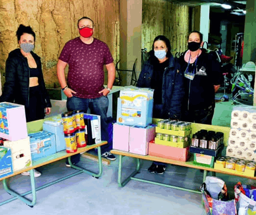 A group of people show a donation of baby materials