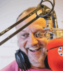 A smiling man in a recording studio