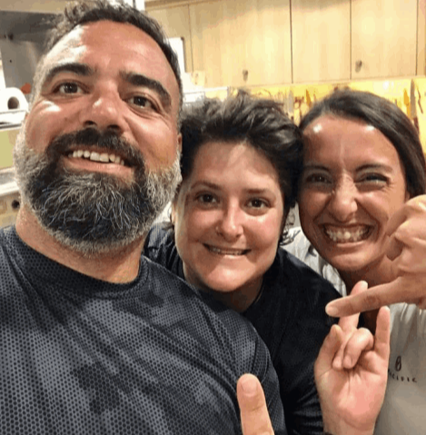 Three smiling people looking at the camera