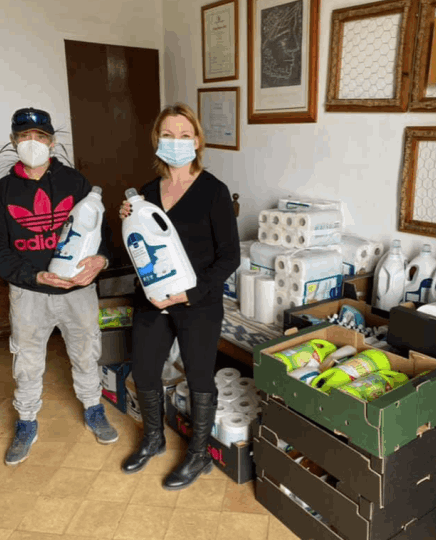 A woman and a man with donated cleaning equipment at can Gazá